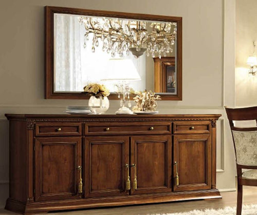 Sideboard with a large mirror above it in a room setting.